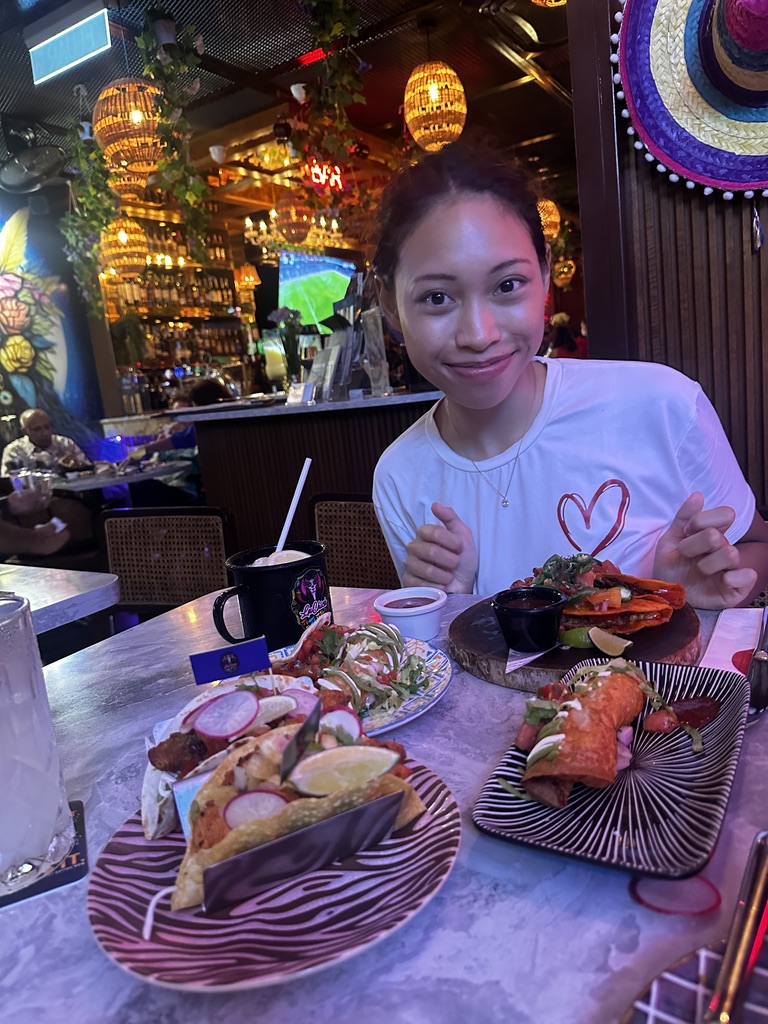 Deha smiling over dinner in July