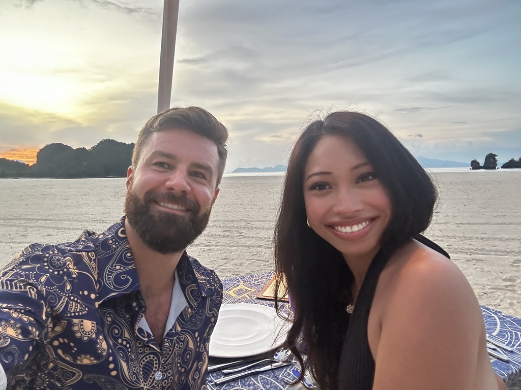 Michael and Deha taking a sunset beach selfie