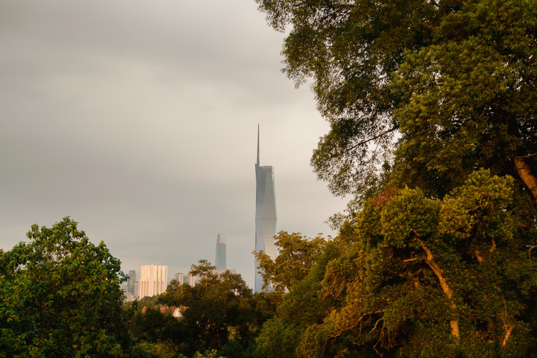 Kuala Lumpur skyline beyond the wedding garden at evening