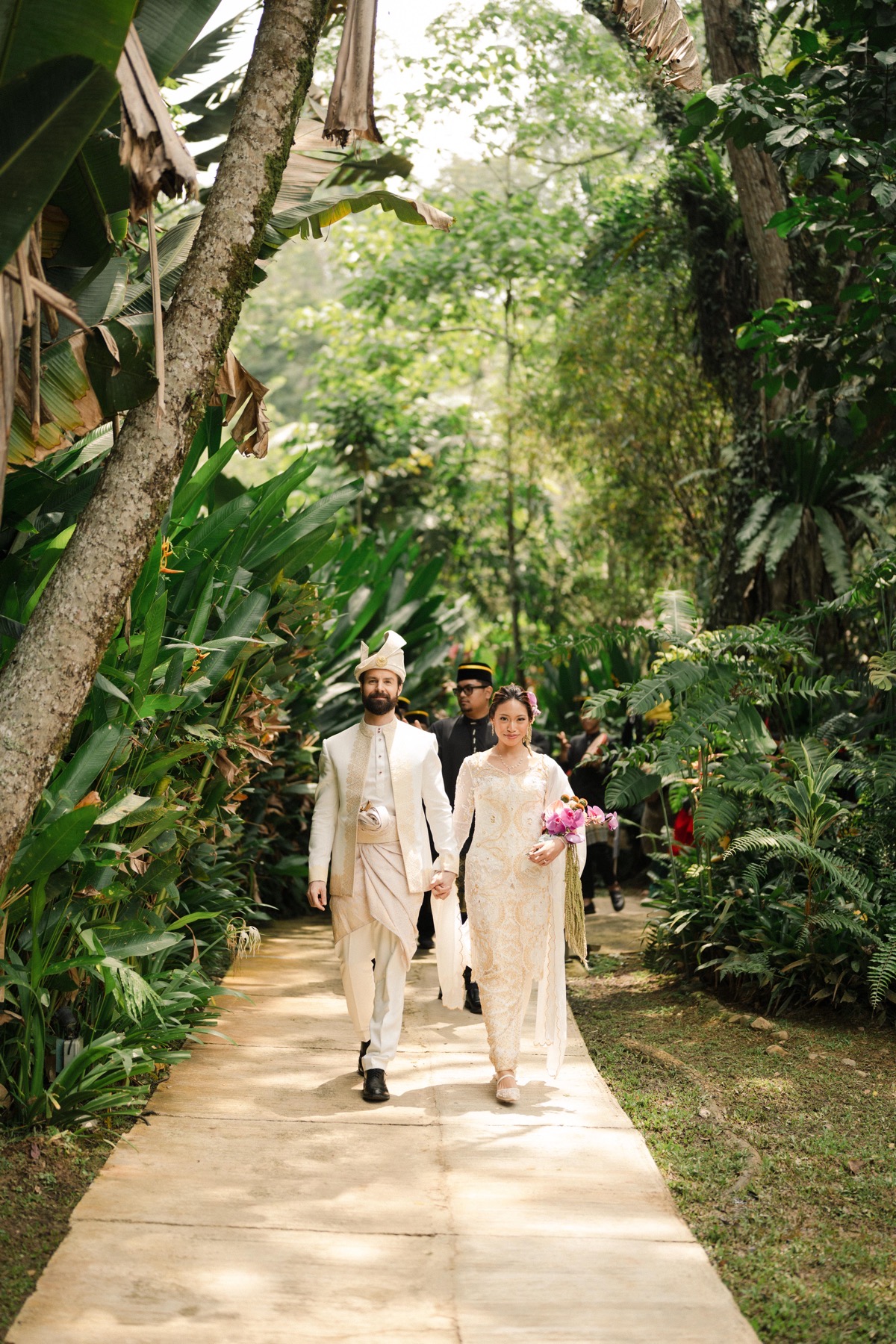 Michael and Deha arriving for the Sanding procession through the garden
